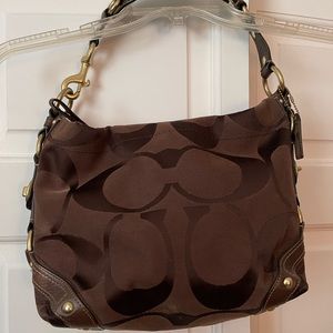 Coach woman’s small brown monogram C embossed fabric bag with leather trim